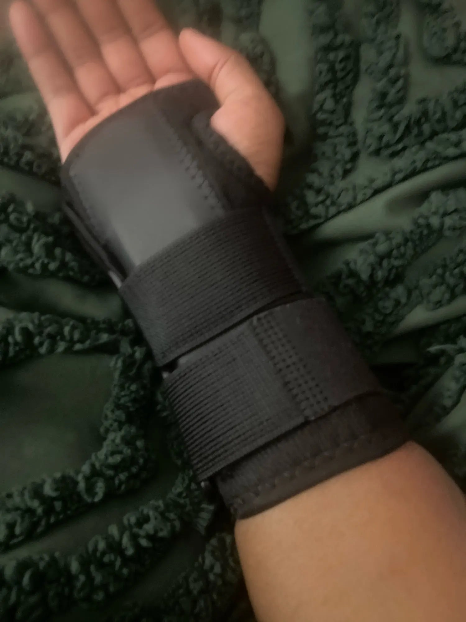 Black two-strap wrist support worn by a purchaser